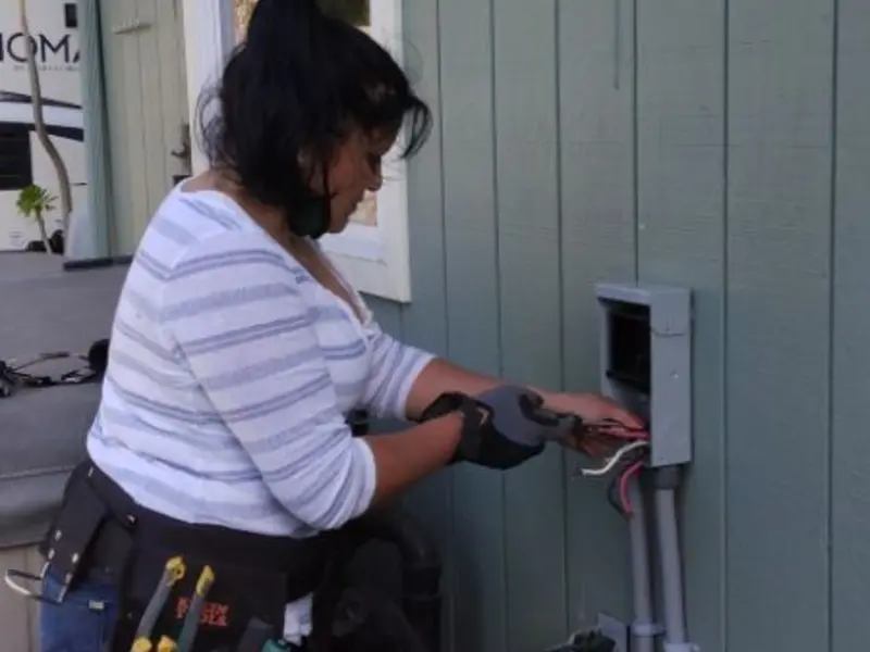 Licensed electrician wiring an exterior subpanel in Tuba City