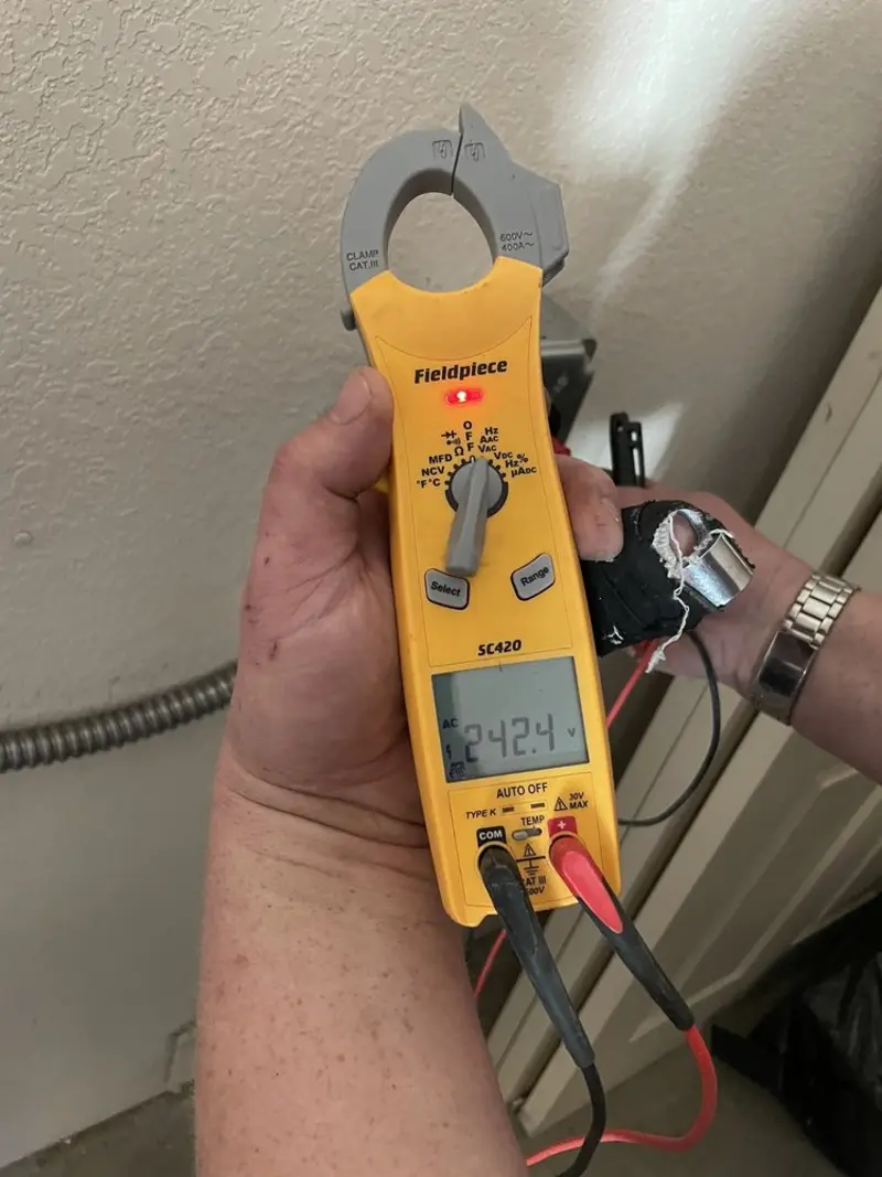 Voltage testing with clamp meter during Outlet Installation in Tuba City